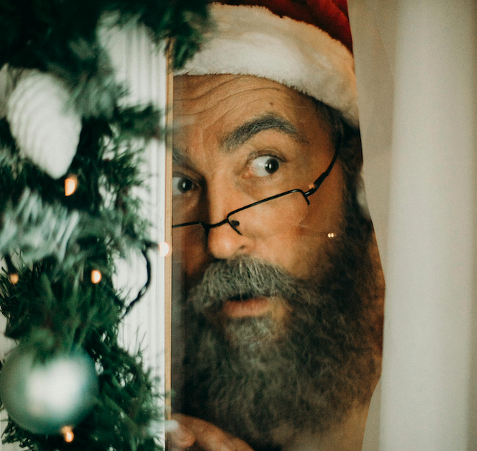 Santa Claus peeking out the window.